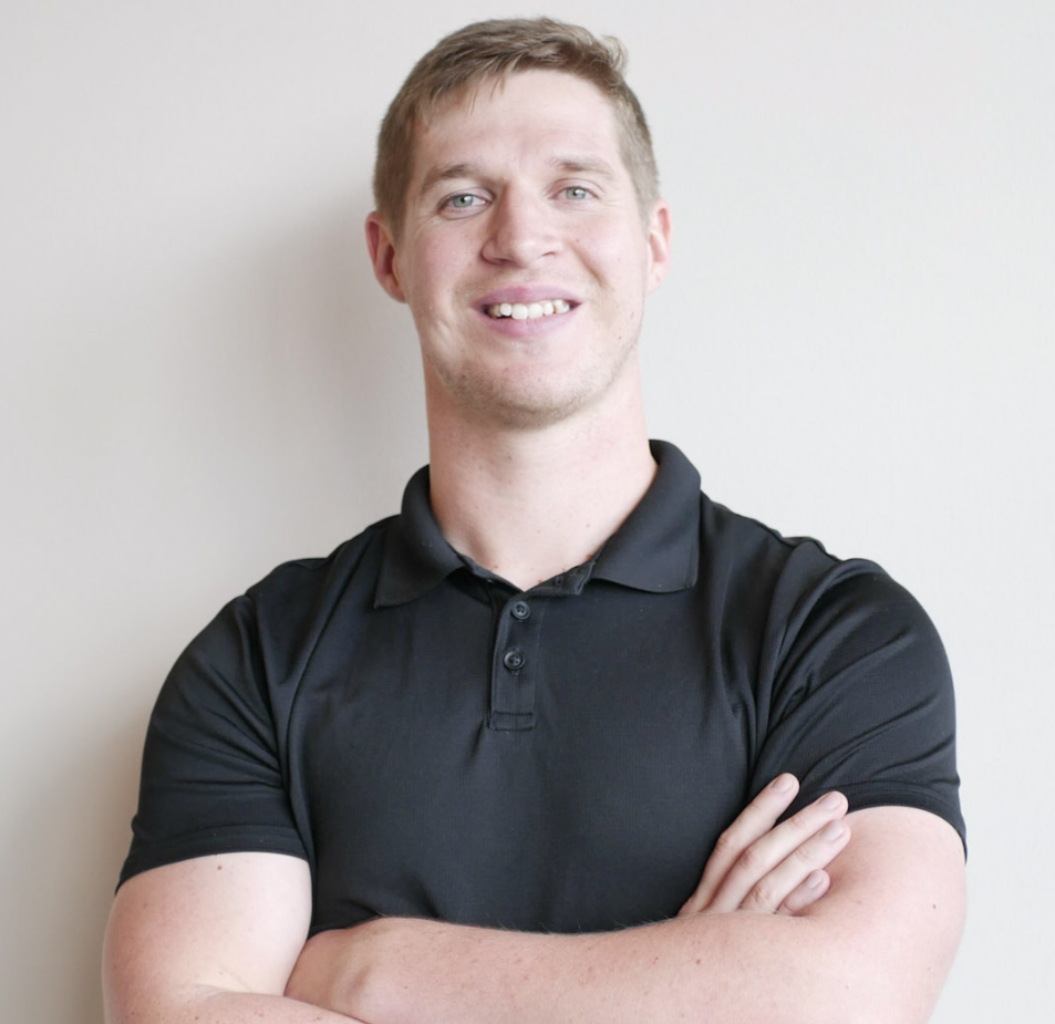 Dr. Cameron Williams smiles with arms crossed