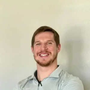 Dr. Cameron Williams smiling with arms crossed in his Colleyville office.