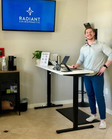 Radiant Chiropractic branding displayed on a screen in the office