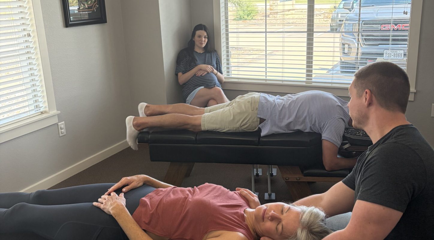 Patient lying on a chiropractic treatment table in a Radiant Chiropractic exam room