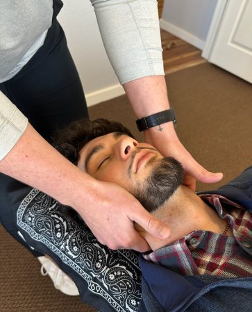 Close-up of hands during a chiropractic head adjustment at Radiant Chiropractic