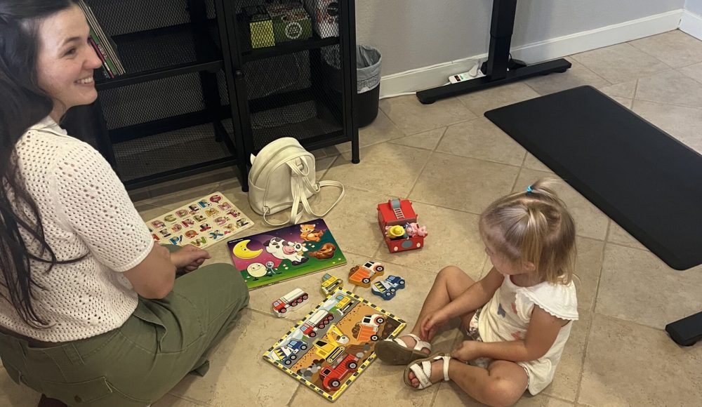 Parent sitting on the floor playing with a toddler at Radiant Chiropractic in Colleyville, TX