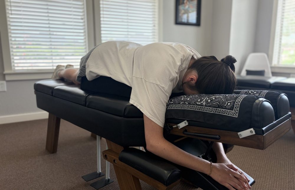 A patient laying on a chiropractic adjustment table at Radiant Chiropractic