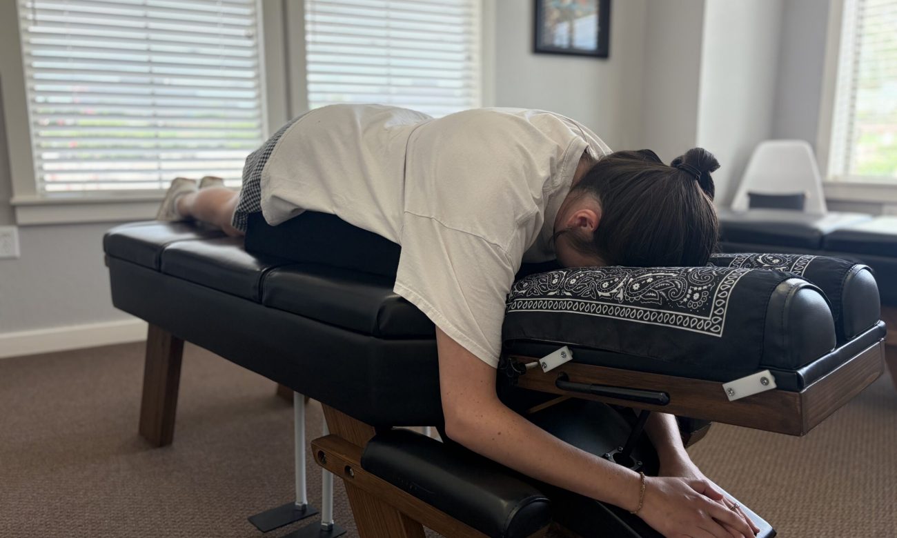 A patient laying on a chiropractic adjustment table at Radiant Chiropractic
